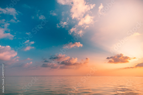 Seascape beach and colorful dream summer sky. Panoramic beach landscape. Empty ocean view, horizon seascape. Orange and golden sunset sky, sun rays, calmness, tranquil relaxing sunlight, summer mood © icemanphotos