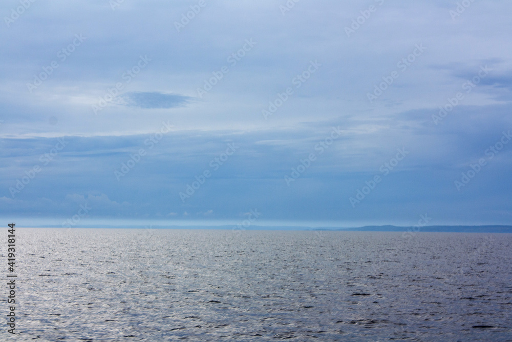 Fototapeta premium Blue sea or ocean water surface, underwater with sunny and cloudy sky