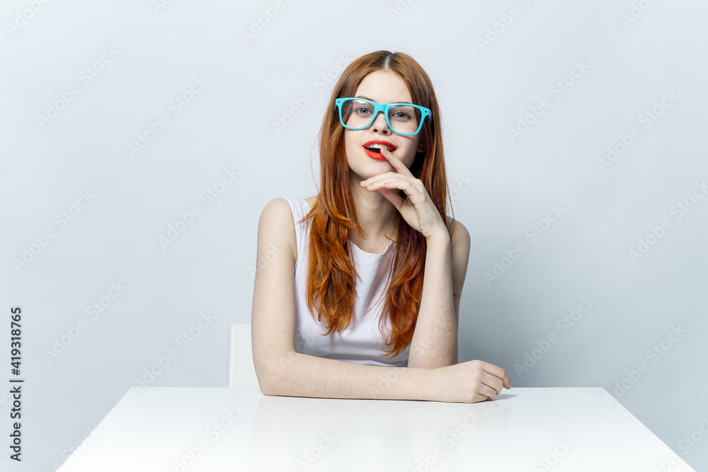 pretty woman red lips blue glasses sitting at the table smile pretty woman red lips blue glasses sitting at the table smile