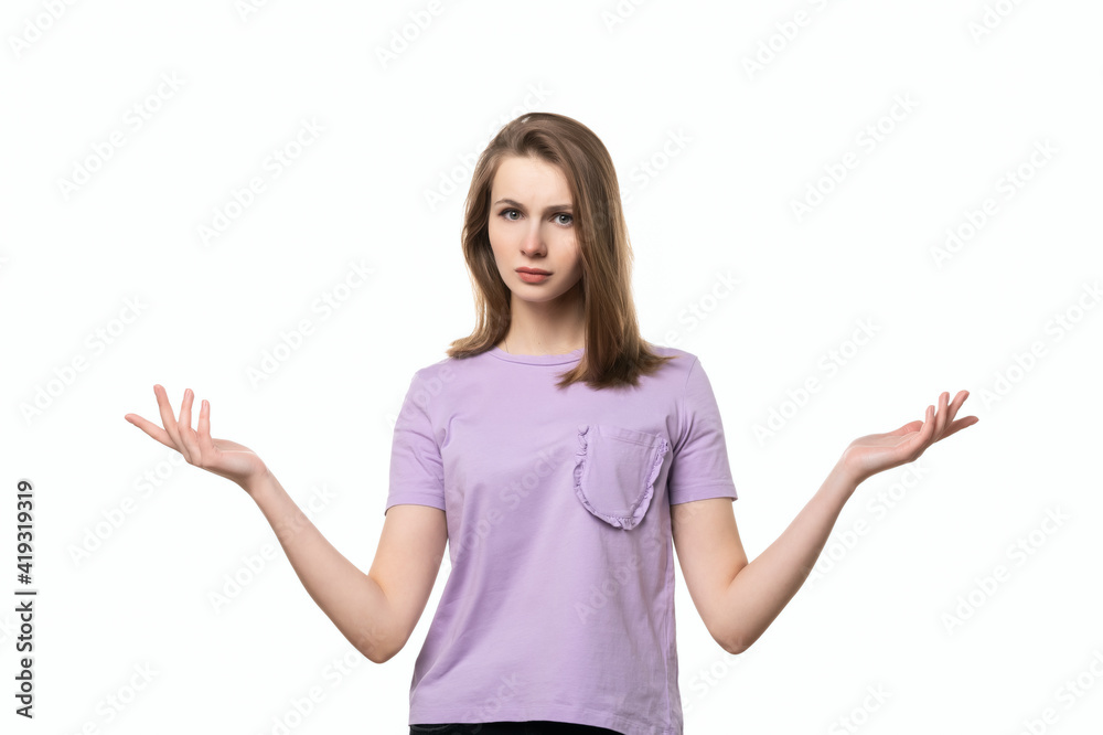 Confused girl shrugging helpless with her shoulders having no idea what to do, white background Confused girl shrugging helpless with her shoulders having no idea what to do, white background