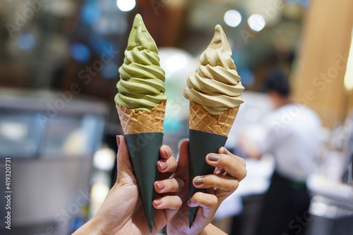 Two soft serve ice cream cone with premium matcha green tea and hojicha.