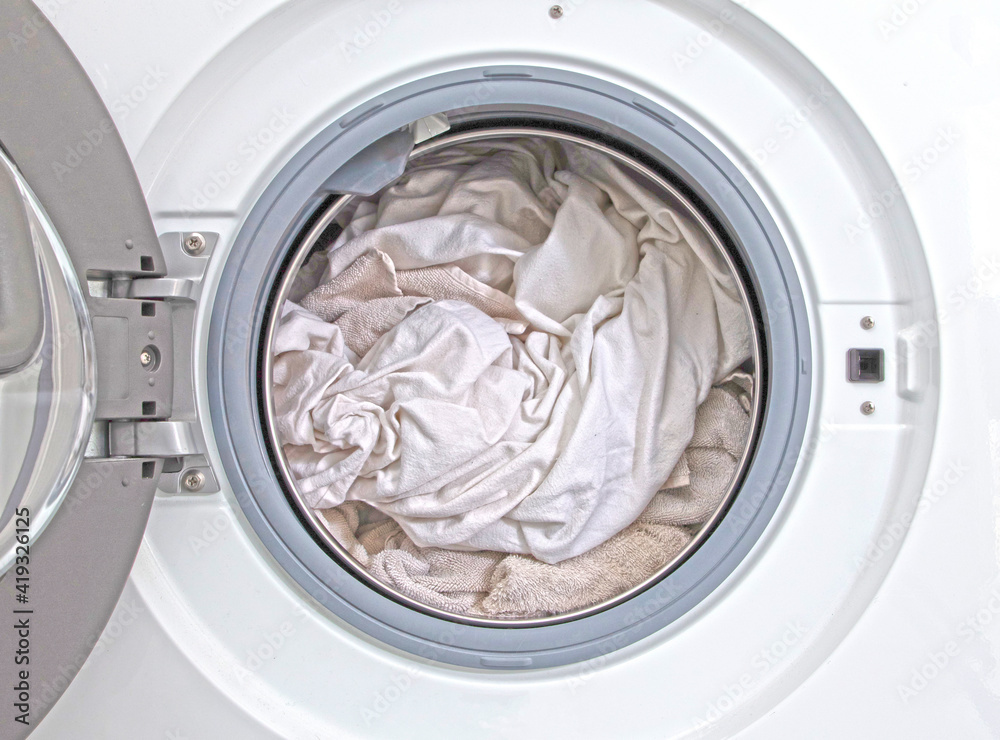 Washing machine filled with white laundry Washing machine filled with white laundry