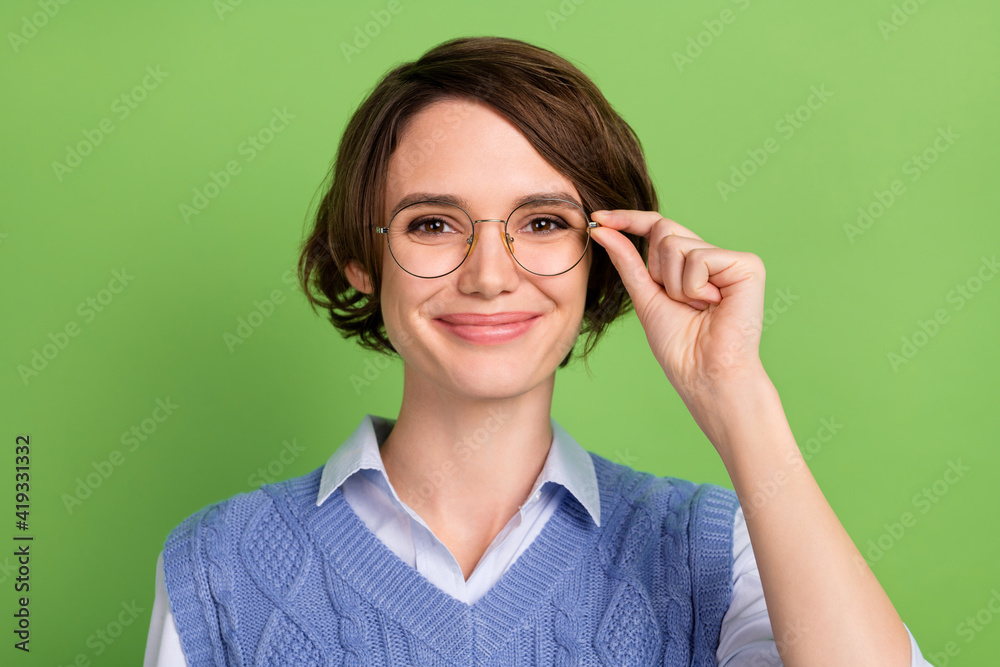 Photo portrait of clever girl in blue vest wearing glasses smiling isolated on vivid green color background
