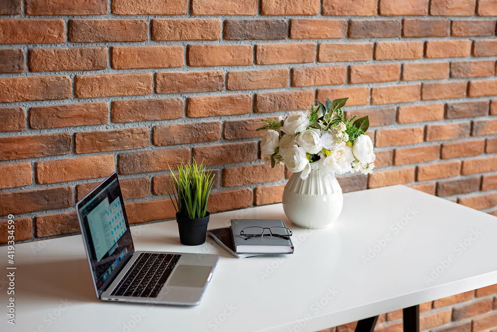 Creative workplace loft brick wall and accessory on white table. copy space, soft selective focus. Creative workplace loft brick wall and accessory on white table. copy space, soft selective focus.