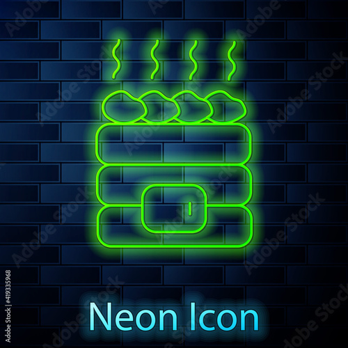 Glowing neon line Hot sauna stones icon isolated on brick wall background. Spa resort recreation, bathhouse relaxation. Hot stones on electric heater. Vector.