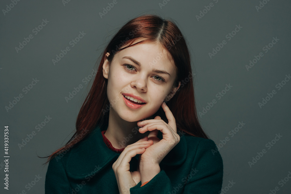 portrait of a red-haired woman on a gray background in dark clothes makeup model portrait of a red-haired woman on a gray background in dark clothes makeup model
