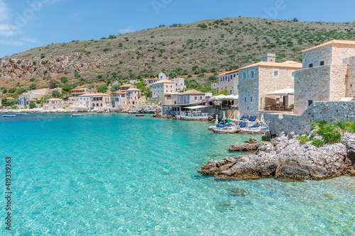 view of  Limeni village with fishing boats in  turquoise waters and the stone buildings as a background  in Mani, South Peloponnese , Greece.