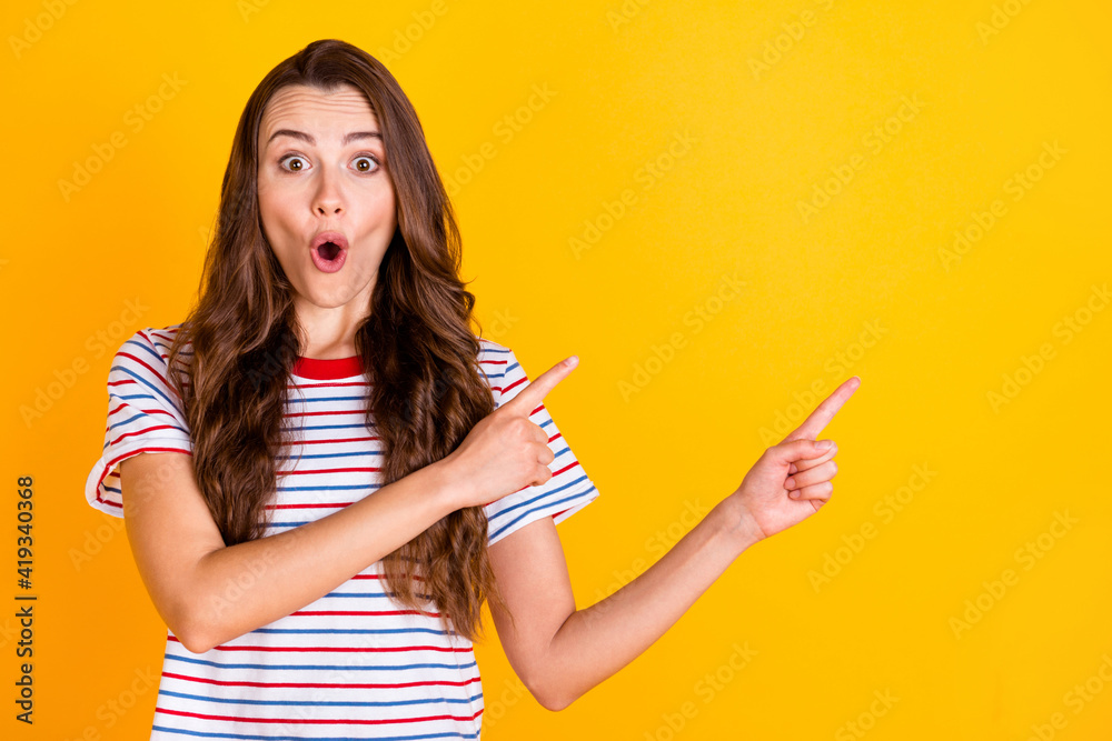 Portrait of attractive amazed cheerful girl demonstrating copy space offer idea isolated over bright yellow color background Portrait of attractive amazed cheerful girl demonstrating copy space offer idea isolated over bright yellow color background