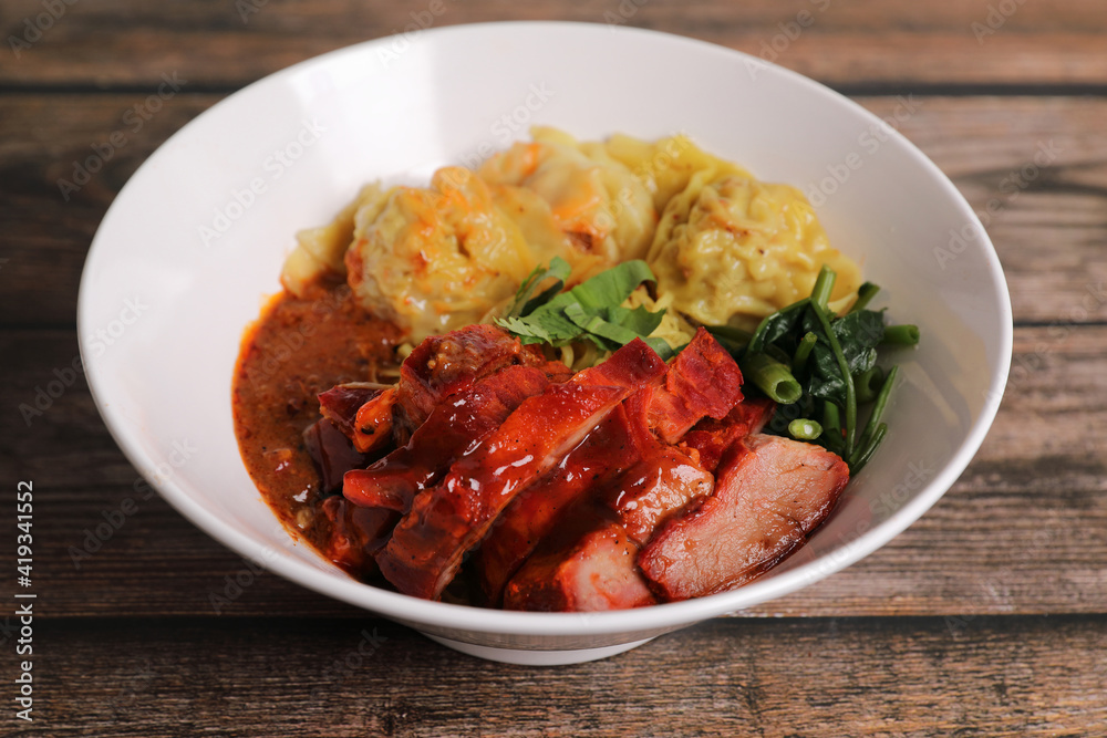 Shrimp dumpling with roasted pork with local thai tom yum spicy sauce on wood background Shrimp dumpling with roasted pork with local thai tom yum spicy sauce on wood background