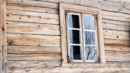 Boarded up windows on the old wooden wall of the house. Carving adorns the old window. Image for design. Countryside concept.