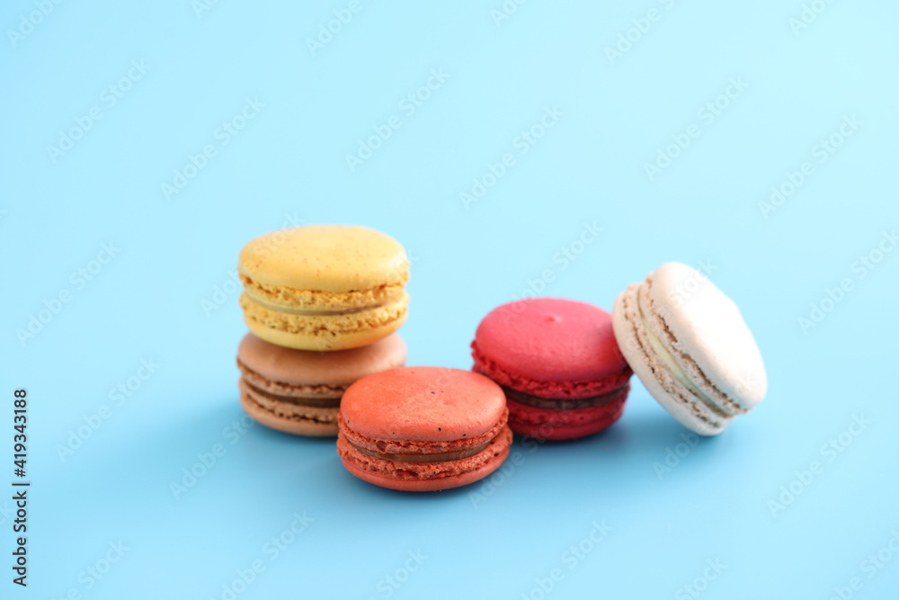 Colorful macarons isolated in blue background Colorful macarons isolated in blue background