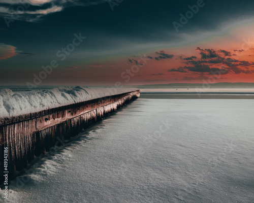 Winter landscape of a lake during sunset