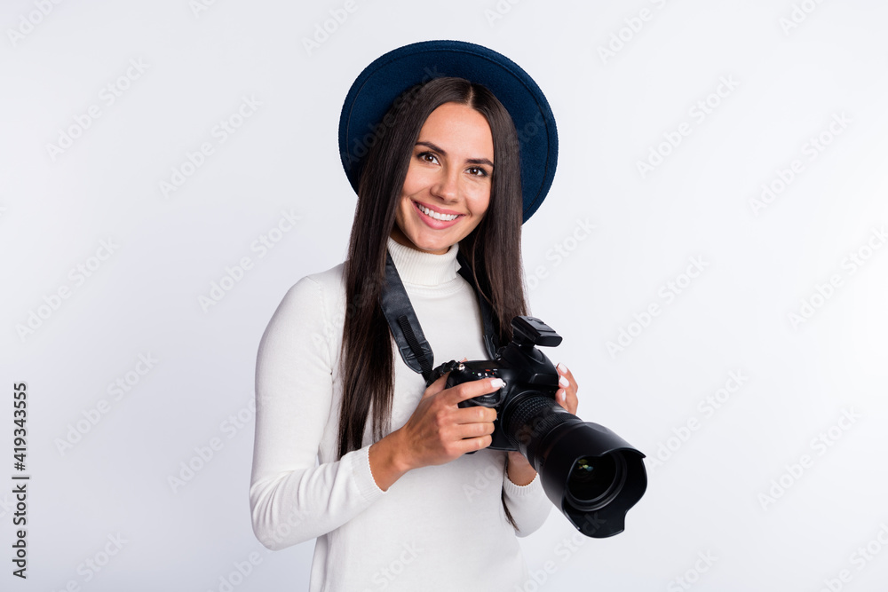 Photo of young happy charming nice lady hold camera professional journalist isolated on grey color background Photo of young happy charming nice lady hold camera professional journalist isolated on grey color background