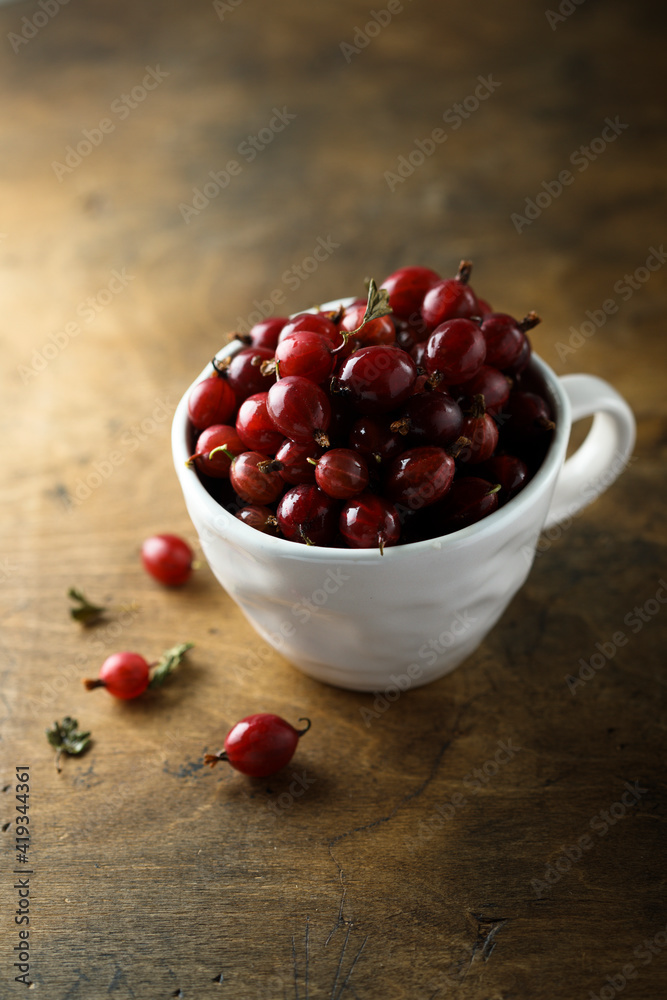 Fresh gooseberry in a white cup Fresh gooseberry in a white cup