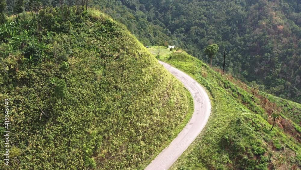 The aerial view of the paved roads on a high mountain can be seen for a long distance with intricate green mountains.
The aerial view of the paved roads on a high mountain can be seen for a long distance with intricate green mountains.
