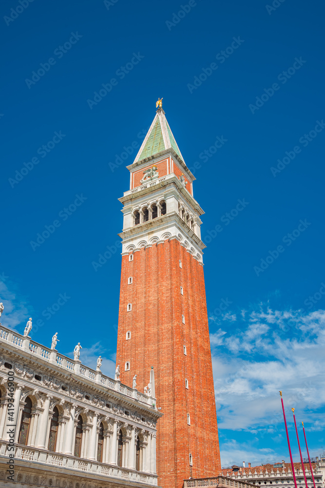 Full size view of Campanile Bell Tower at San Marco square in Venice, Italy, at sunny day and deep blue sky.