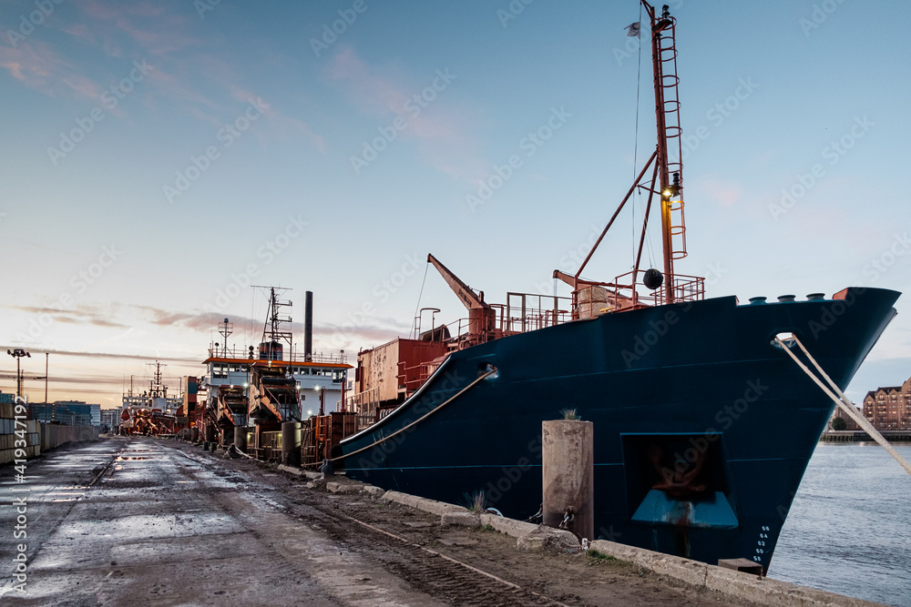 Cargo ship in docklands london sunset. Cargo ship in docklands london sunset.