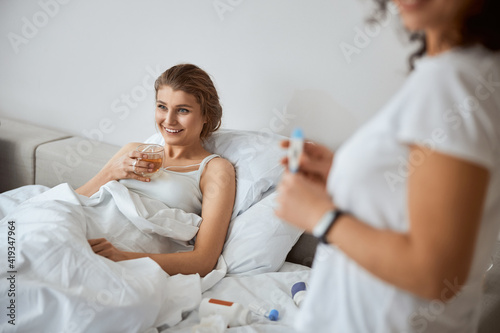 Positive delighted woman feeling better after bed rest