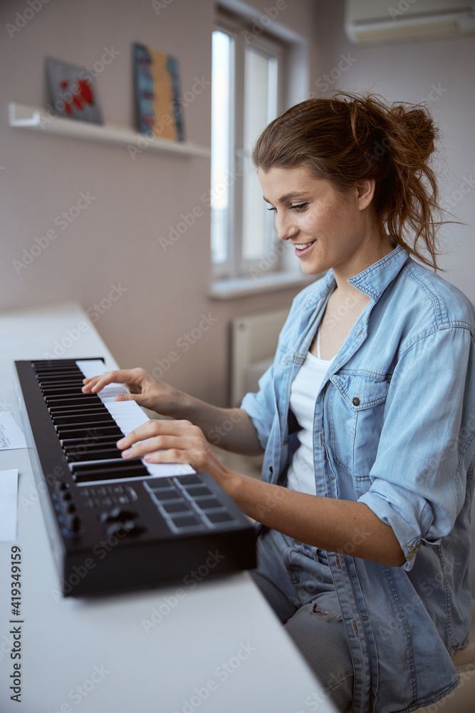 Delighted young musician playing her favorite melody Delighted young musician playing her favorite melody