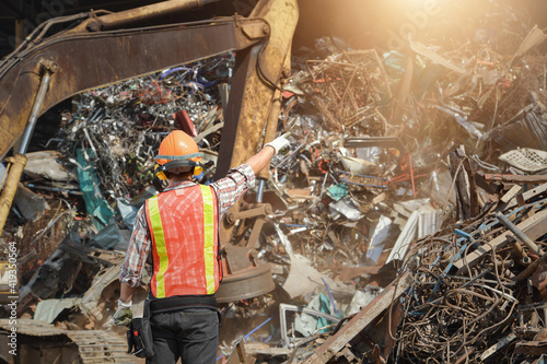 Recycling industry a worker who recycling thing on recycle center.Manager and Manual Worker in Metal Landfill