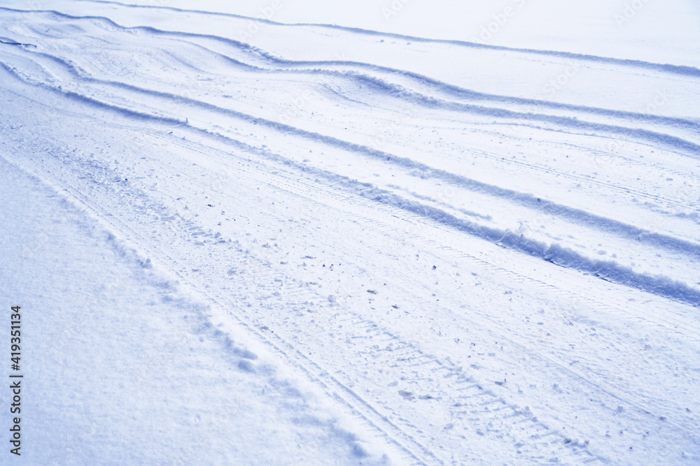 Rolled winter country road with a snow car tracks. Rolled winter country road with a snow car tracks.