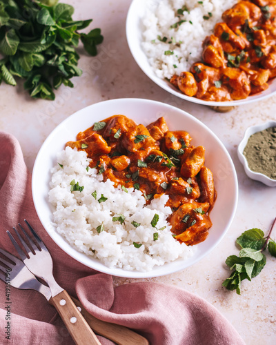 Obraz na plátně Chicken tikka masala and rice in white bowl on neutral table top