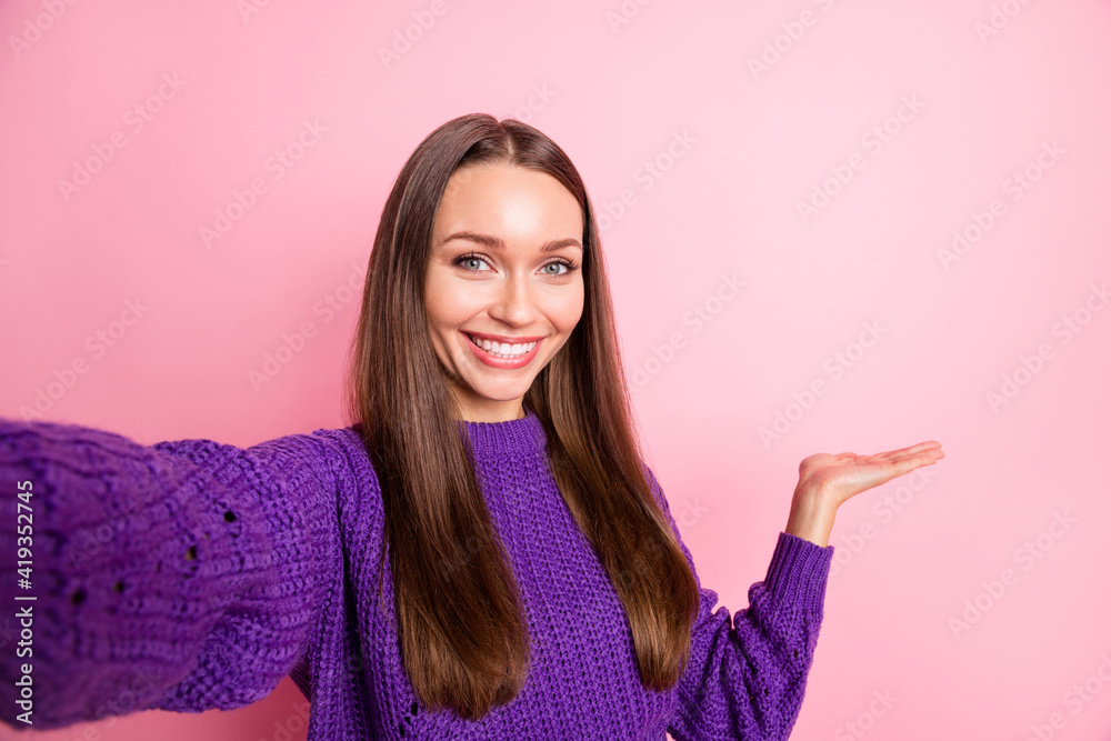 Photo of pretty positive person take selfie hand indicate empty space isolated on pink color background Photo of pretty positive person take selfie hand indicate empty space isolated on pink color background