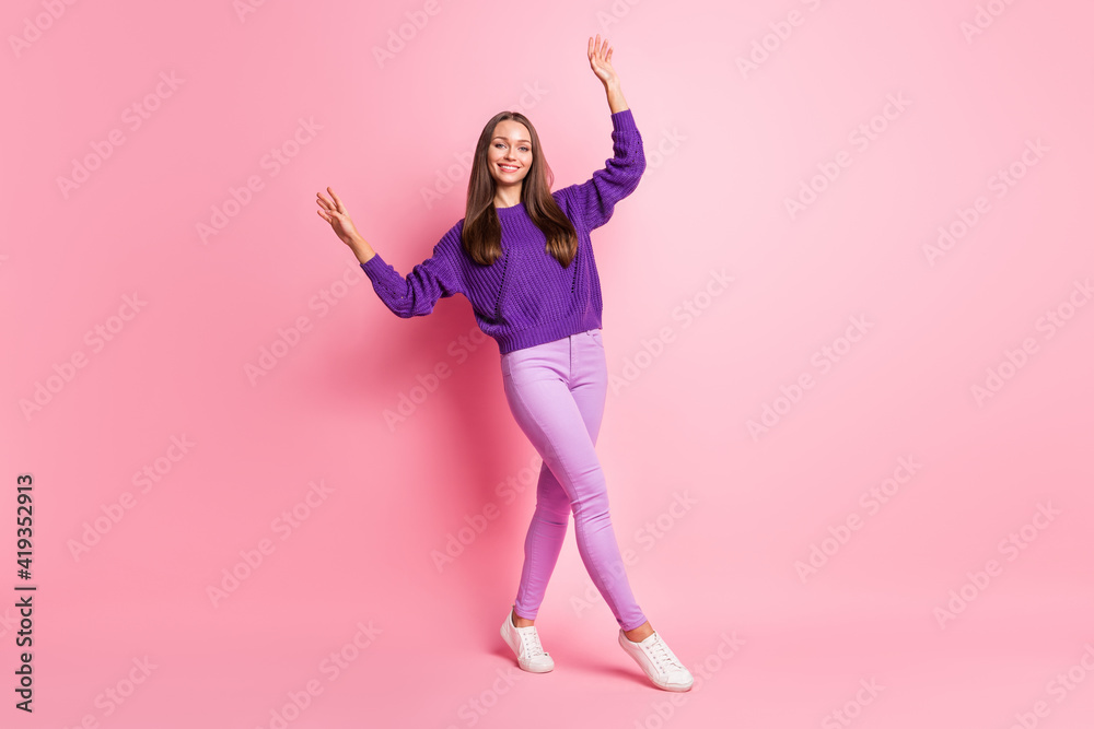 Full length photo of lady dance raise hands wear purple sweater pants footwear isolated pink color background