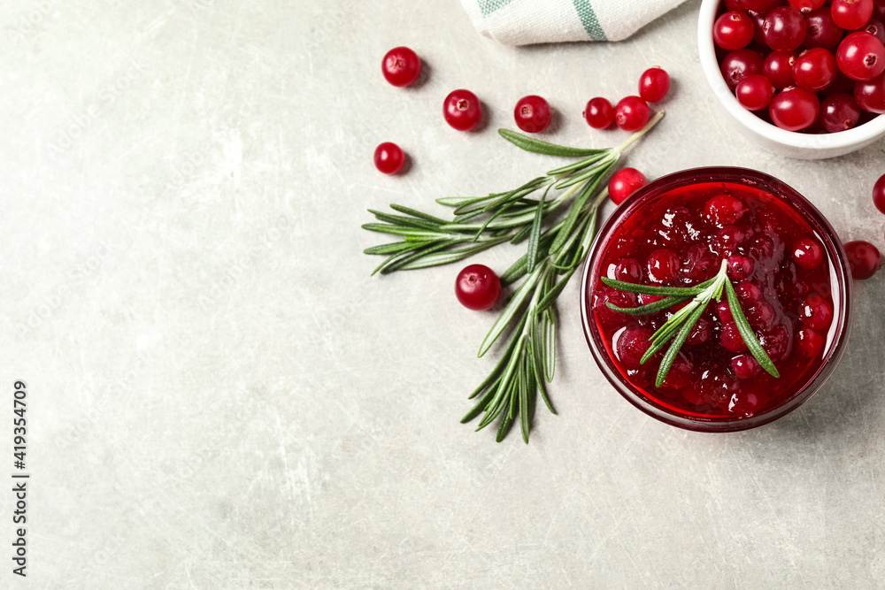 Cranberry sauce, rosemary and fresh berries on light table, flat lay. Space for text Cranberry sauce, rosemary and fresh berries on light table, flat lay. Space for text
