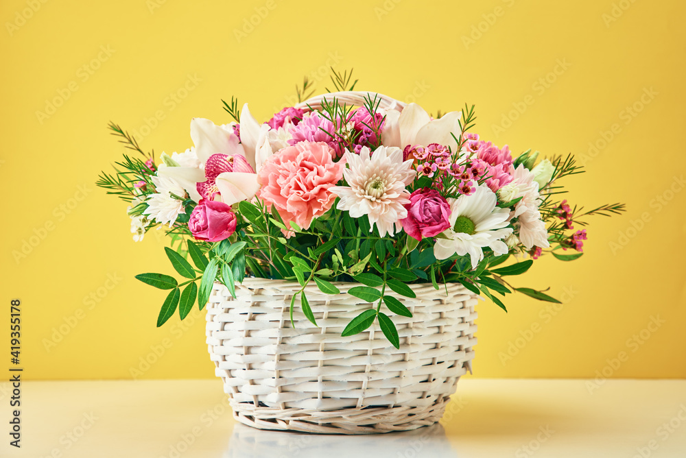 Bunch of fresh summer flowers on the yellow background