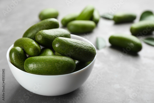 Slika na platnu Bowl with fresh seedless avocados on grey table, closeup