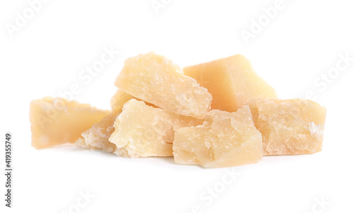 Pieces of delicious parmesan cheese on white background