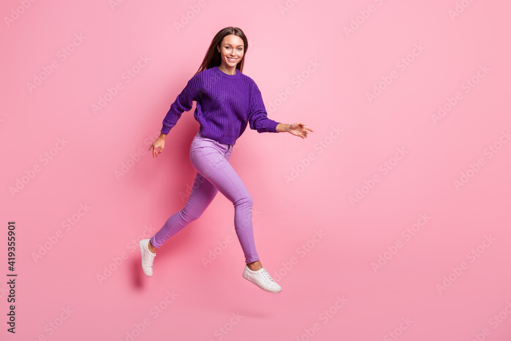 Full length profile photo of attractive positive girl running toothy smile look camera isolated on pink color background