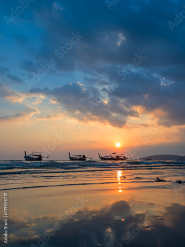 Traditional thai boats at sunset beach. Ao Nang Krabi province