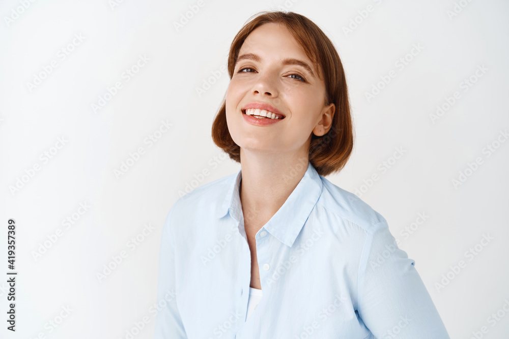 Portrait of young businesswoman smiling on white studio background. Female entrepreneur in office blouse, standing motivated and self-assured Portrait of young businesswoman smiling on white studio background. Female entrepreneur in office blouse, standing motivated and self-assured