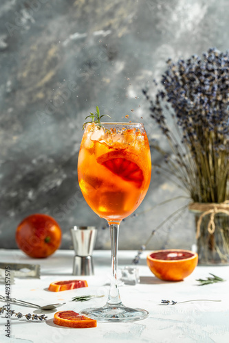 Aperol spritz cocktail. Italian cocktail with bloody oranges, red bitter, dry white wine, soda, zest and ice. freeze motion in jar glass