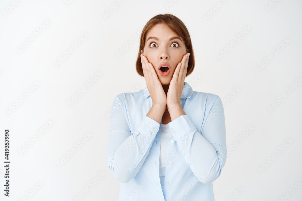 Portrait of surprised businesswoman gasping and staring with disbelief at camera, saying wow amazed, checking out awesome advertisement, white background Portrait of surprised businesswoman gasping and staring with disbelief at camera, saying wow amazed, checking out awesome advertisement, white background