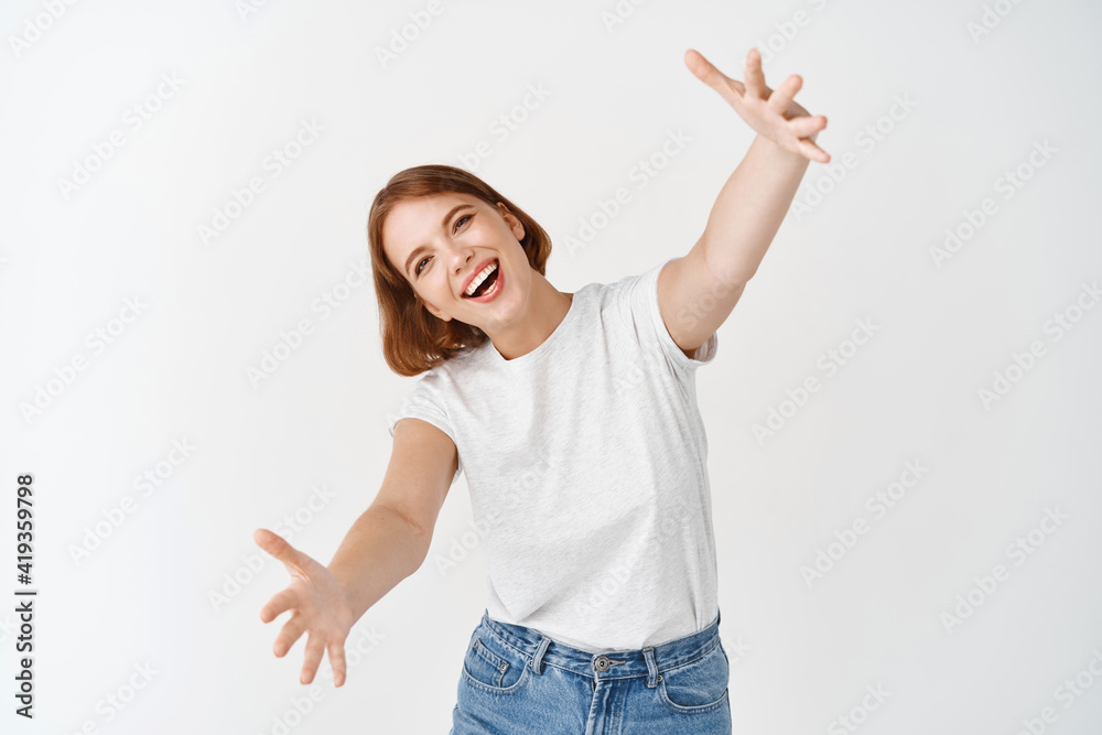 Come her for hug. Smiling happy woman stretch out hands for cuddle, welcome you, wants to embrace person, standing against white background