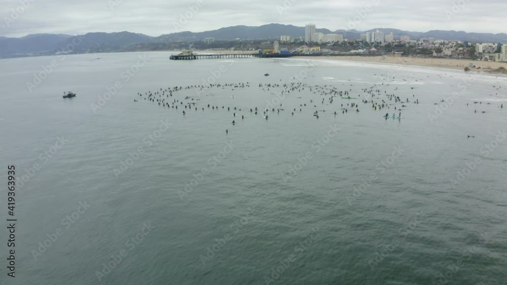 Aerial Backward: Protestors Forming Paddle Out In Sea Against Sky Aerial Backward: Protestors Forming Paddle Out In Sea Against Sky