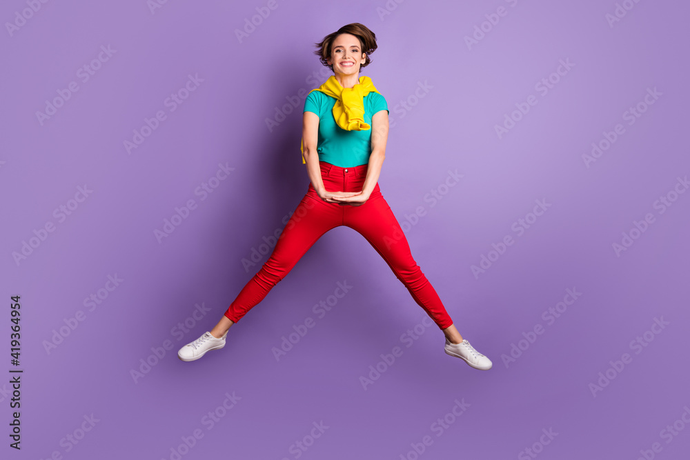 Full length photo of lady jump hold palms wear knotted sweater t-shirt trousers sneakers isolated violet color background
