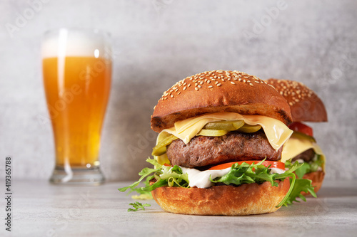 burger with cutlet and glass of cold beer