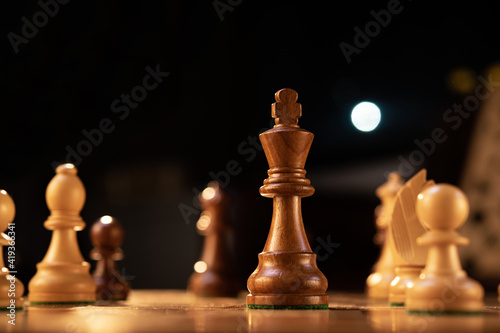 Wooden chess king on the game board