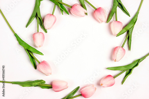 Round floral frame from tulips flowers on white background.