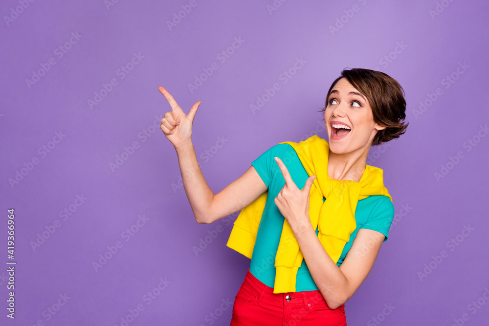 Photo of lady indicate forefingers look empty space wear knotted pullover t-shirt isolated violet color background Photo of lady indicate forefingers look empty space wear knotted pullover t-shirt isolated violet color background
