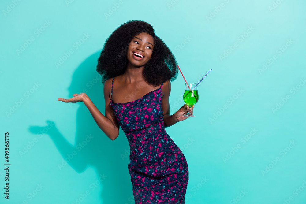 Photo portrait of pretty girl on holidays drinking cocktail smiling happy overjoyed isolated on vibrant teal color background Photo portrait of pretty girl on holidays drinking cocktail smiling happy overjoyed isolated on vibrant teal color background