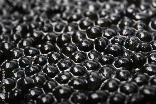 Closeup of black caviar on a background
