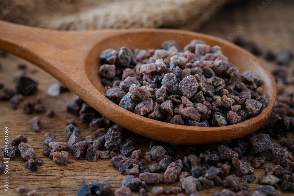 Himalayan black rock salt on wooden spoon Himalayan black rock salt on wooden spoon