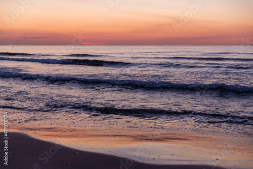 sunrise over the water with beautiful colors at malvarosa beach of the City of valencia, costa blanca, spain