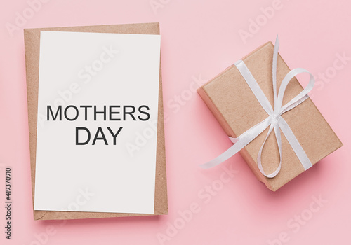 Gifts with note letter on isolated pink background, love and valentine concept with text mothers Day