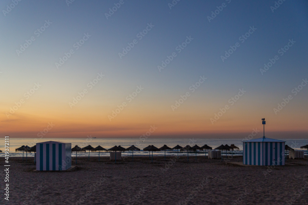 Fototapeta premium sunrise with beautiful colors at malvarosa beach of the City of valencia, costa blanca, spain